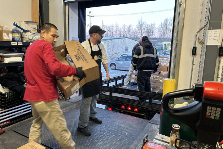 Workers offloading boxes at Bean's Cafe