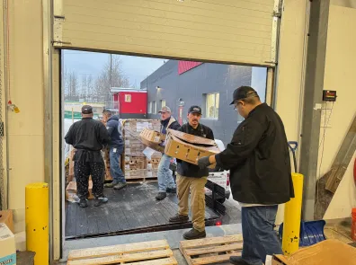 Turkeys are unloaded on a loading dock