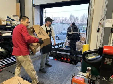 Workers offloading boxes at Bean's Cafe