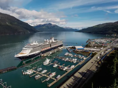A cruise ship docked at Whittier port on a sunny summer day.