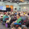 CEO Arthur Miller speaks to a crowd at the 2025 Chugach Electric Annual Meeting.