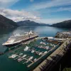 A cruise ship docked at Whittier port on a sunny summer day.