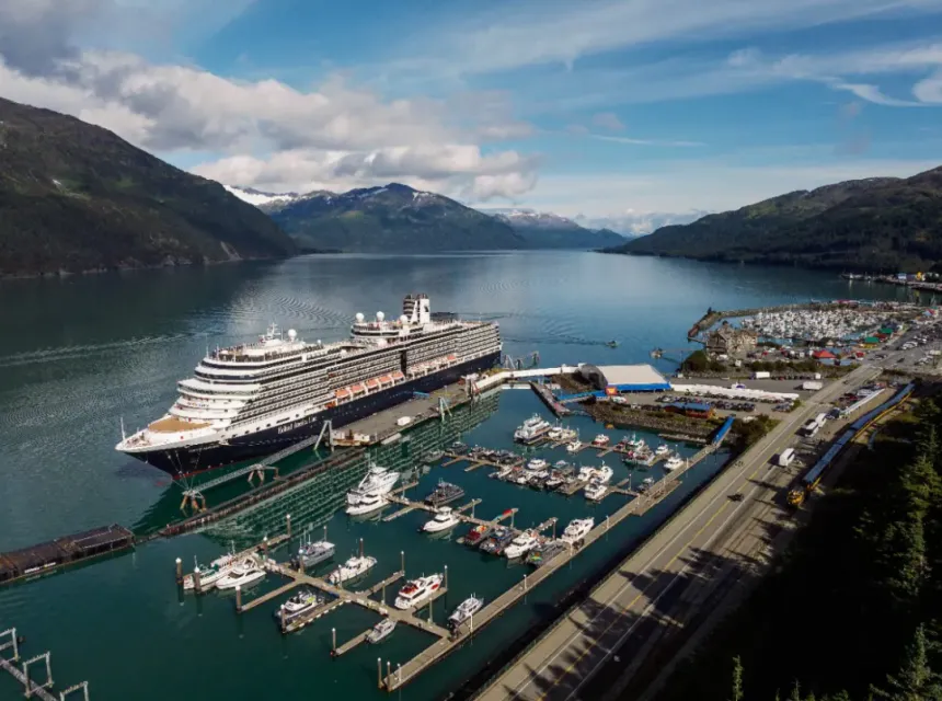 A cruise ship docked at Whittier port on a sunny summer day.